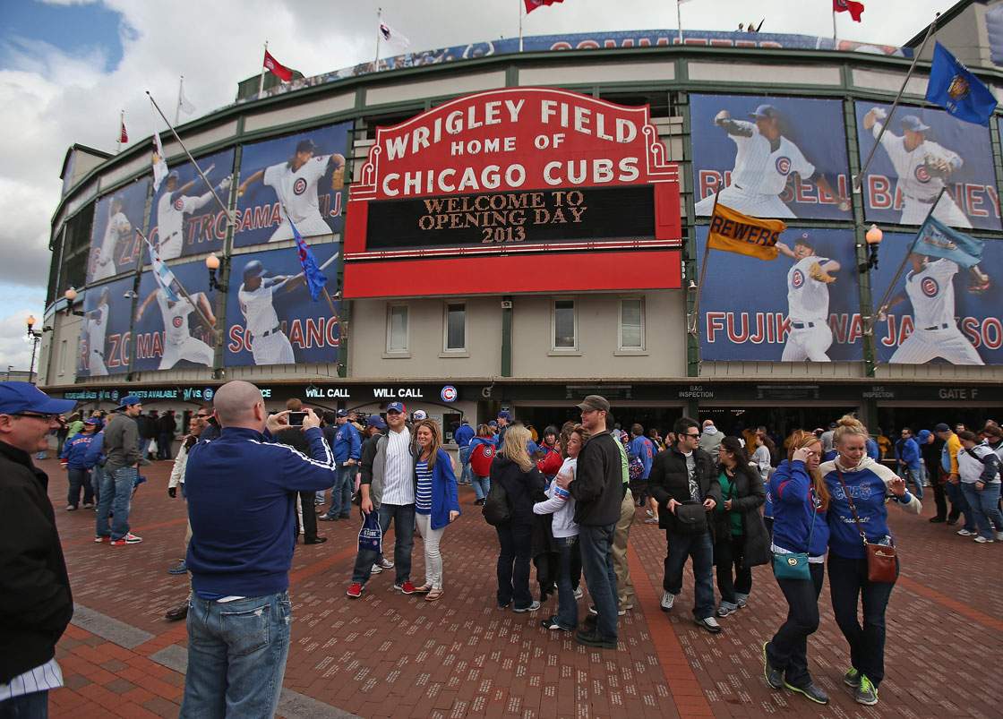 Fans take pictures outside the main entrance to Wrigley Field before the Opening Day game between the Chicago Cubs and the Milwaukee Brewers on April 8, 2013 in Chicago, Illinois.  