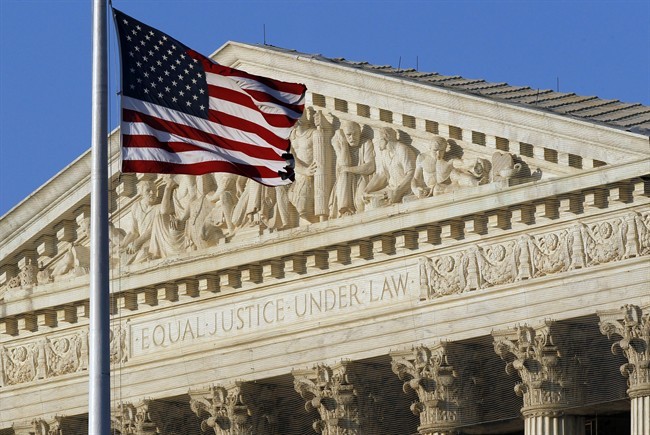 FILE - In this June 27, 2012 file photo, an American flag flies in front of the Supreme Court in Washington. 