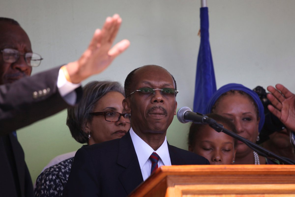Haiti's former President Jean-Bertrand Aristide prepares to speak upon arrival to the the airport in Port-au-Prince, Haiti, Friday March 18, 2011.