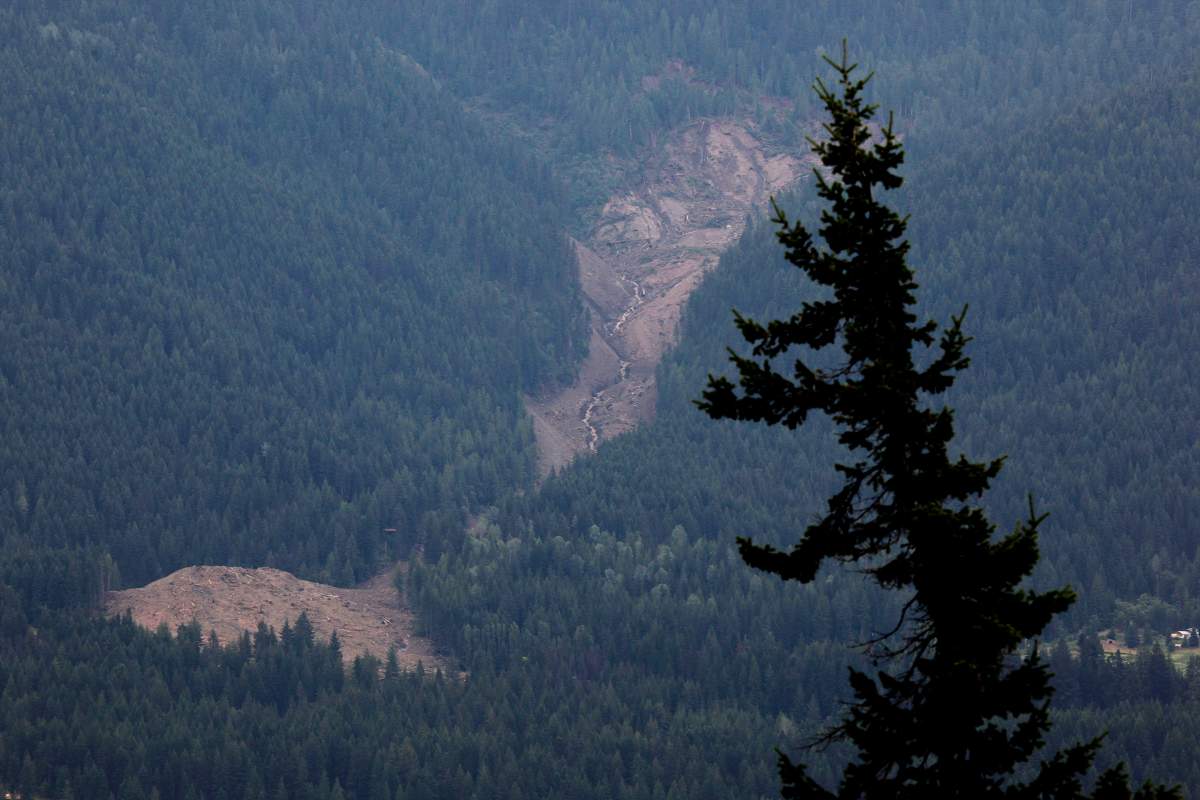 The swath of a landslide that buried three homes and has left four people unaccounted for in Johnsons Landing, B.C., is seen from across Kootenay Lake Saturday, July 14, 2012.THE CANADIAN PRESS/Jeff McIntosh.