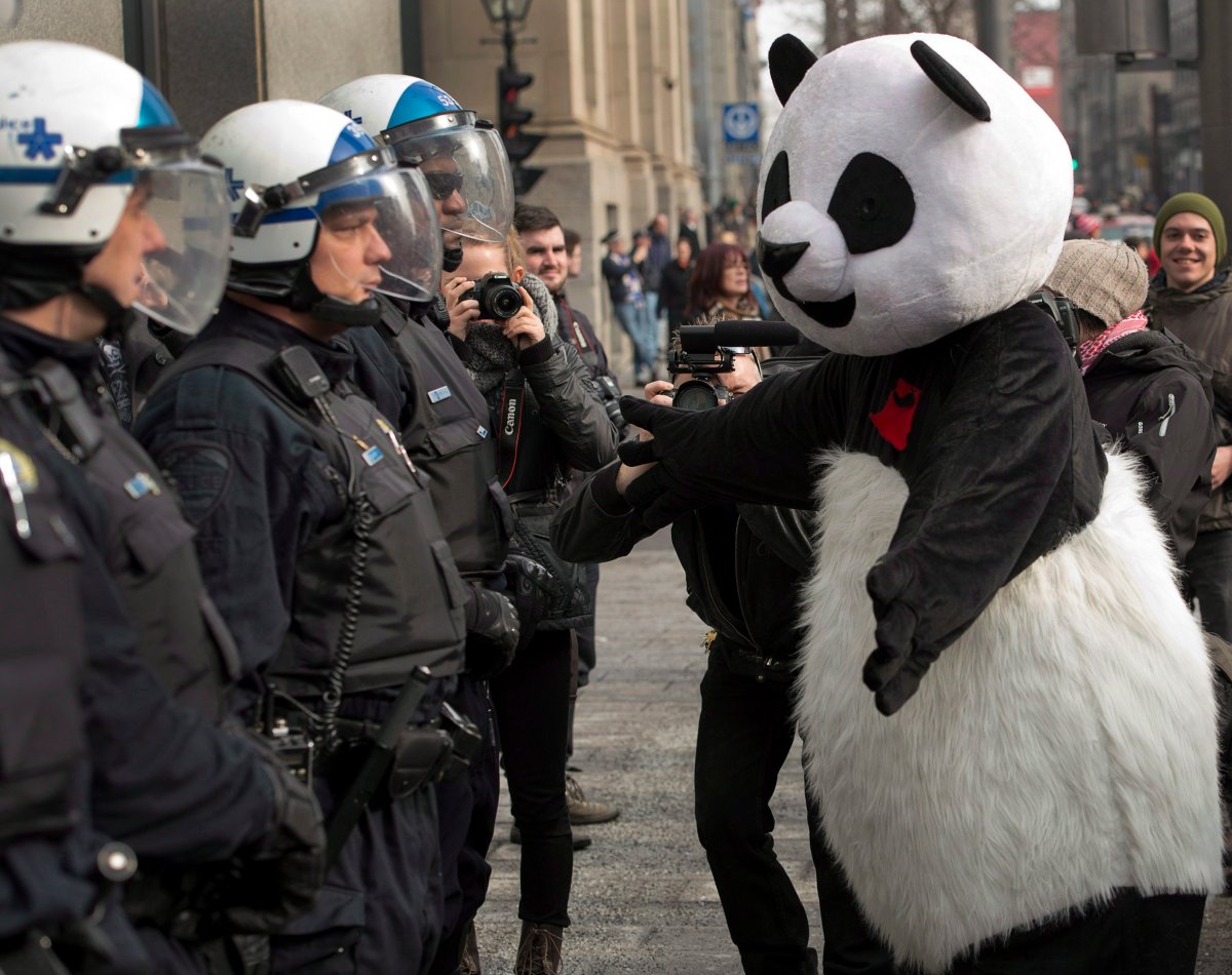Anarchopanda greets riot police at the start of a student protest against tuition fee hikes, Tuesday, February 26, 2013 in Montreal.