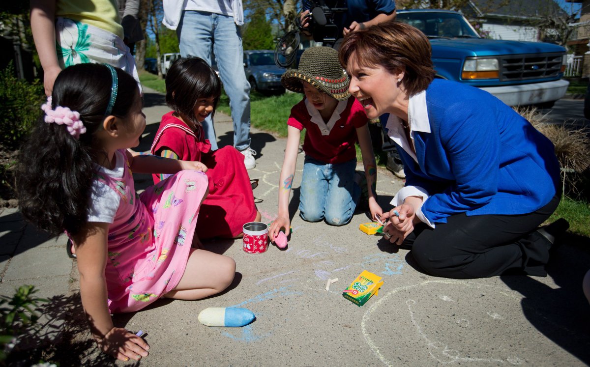 British Columbia Premier and Liberal Leader Christy Clark, right, stops to talk to young girls drawing on the sidewalk with chalk after a provincial election campaign stop at the house next door in Vancouver, B.C., on Sunday May 5, 2013. British Columbians go to the polls for a provincial election May 14. THE CANADIAN PRESS/Darryl Dyck.