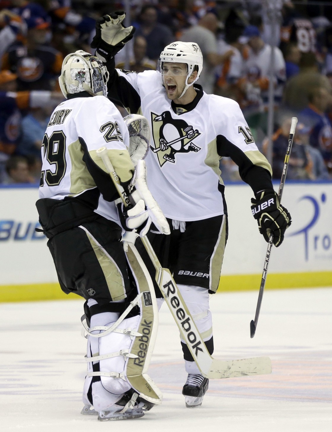 Pittsburgh Penguins' Brandon Sutter, right, and goalie Marc-Andre Fleury celebrate their overtime win against the New York Islanders in Game 3 of an NHL hockey Stanley Cup first-round playoff series on Sunday, May 5, 2013, in Uniondale, N.Y. The Penguins defeated the Islanders 5-4.