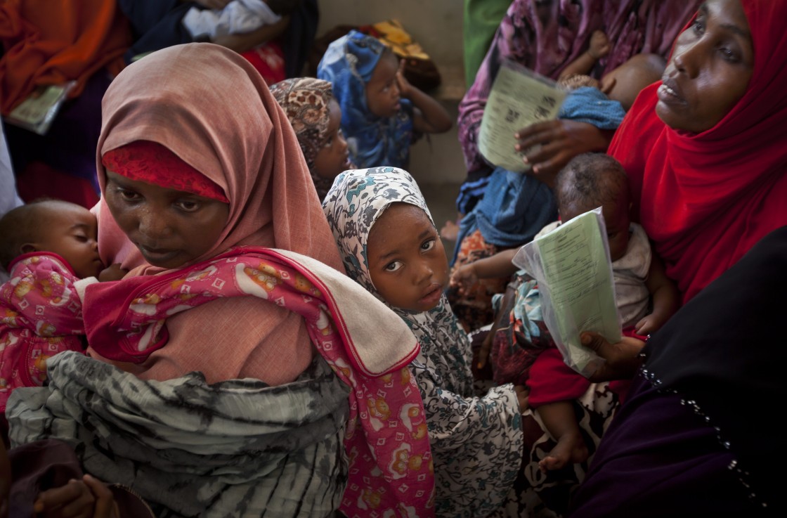 In this Wednesday, April 24, 2013 file photo, Somali mothers and their babies wait in line for the babies to receive a five-in-one vaccine against several potentially fatal childhood diseases, at the Medina Maternal Child Health center in Mogadishu, Somalia.