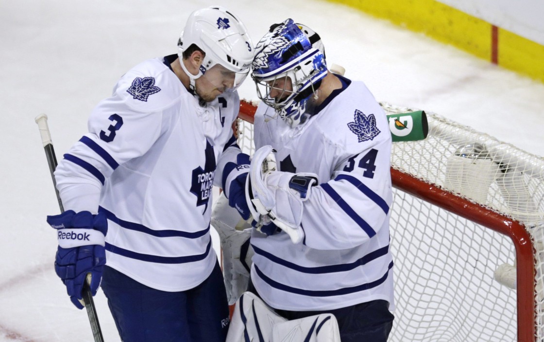 Toronto Maple Leafs goalie James Reimer, right, is congratulated by teammate Dion Phaneuf after the Maple Leafs defeated the Boston Bruins 2-1 in Game 5 of an NHL hockey Stanley Cup playoff series, in Boston on Friday, May 10, 2013.