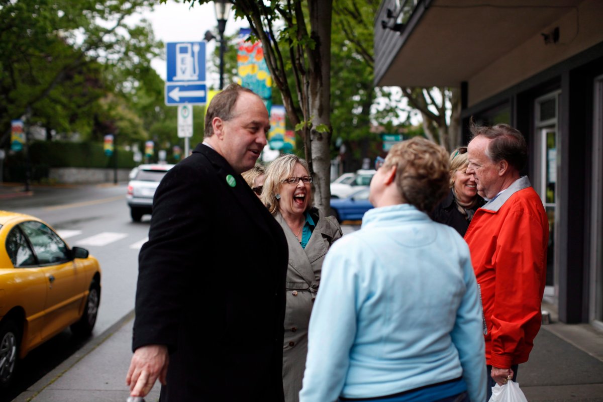 Federal Green Party leader Elizabeth May and Oak Bay/Gordon Head B.C. Green Party MLA candidate Andrew Weaver brave the elements to wave at traffic along Oak Bay Ave. and Monterrey Ave. in Victoria Monday May 13, 2013.