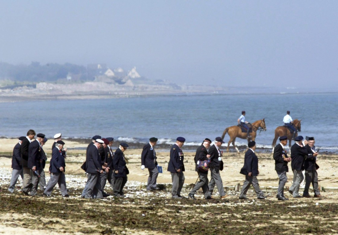 Canadian veterans make their way down Juno beach to the water's edge following a ceremony marking the 60th Anniversary of D-Day in Courseulles-sur-Mer, France, on the Normandy coast on June 6, 2004. The view could change if a plan to build an army of wind turbines some 10 kilometres off the shore succeeds.