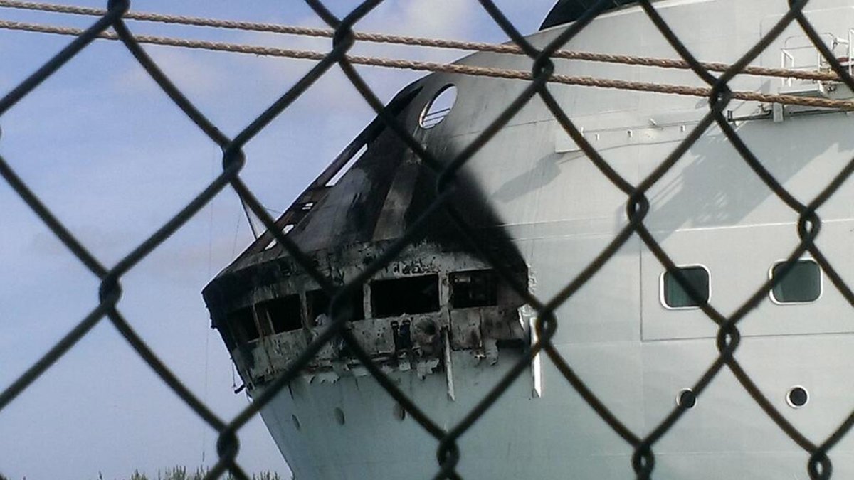 This photo provided by Royal Caribbean shows the fire-damaged exterior of Royal Caribbean's Grandeur of the Seas cruise ship, in Freeport, Bahamas. 