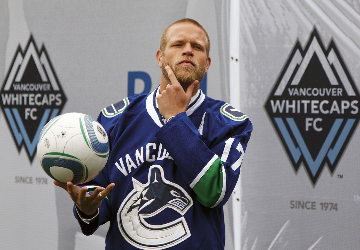 VANCOUVER, BC - MAY 11:  Jay DeMerit #6 of the Vancouver Whitecaps FC sports a Vancouver Canucks jersey as he rubs his playoff beard before the start of their MLS match against the San Jose Earthquakes May 11, 2011 in Vancouver, British Columbia, Canada.  (Photo by Jeff Vinnick/Getty Images).