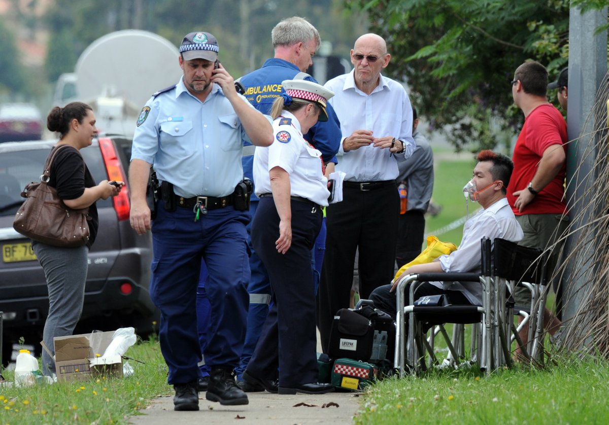 Roger Dean gets treated by emergency responders outside the Quaker Hills Nursing Home on Nov. 18, 2011. Dean pleaded guilty to 11 counts of murder, in Australian court on Monday, for setting the blaze that killed the elderly residents.