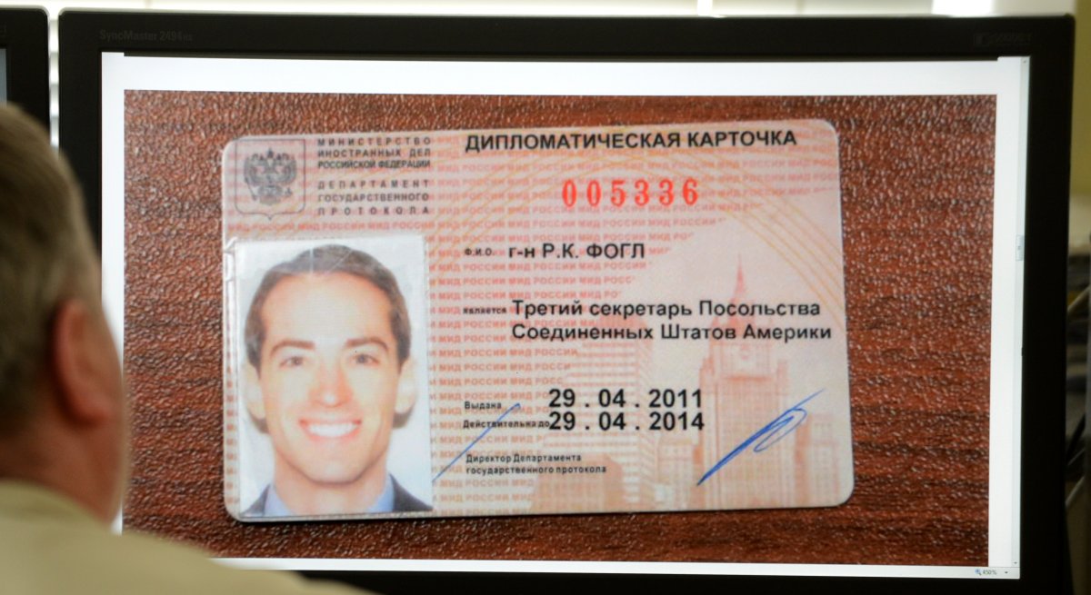 A man looks in Moscow on May 14, 2013, at a computer screen displaying a photo published by Russian state English language television RT website, which shows an ID card, of as Ryan C. Fogle, the third secretary of the political section of Washington's embassy in Moscow, being displayed at the Federal Security Service after his arrest. Russia said today it had detained an alleged American CIA agent working undercover at the US embassy who was discovered with a large stash of money as he was trying to recruit a Russian intelligence officer.