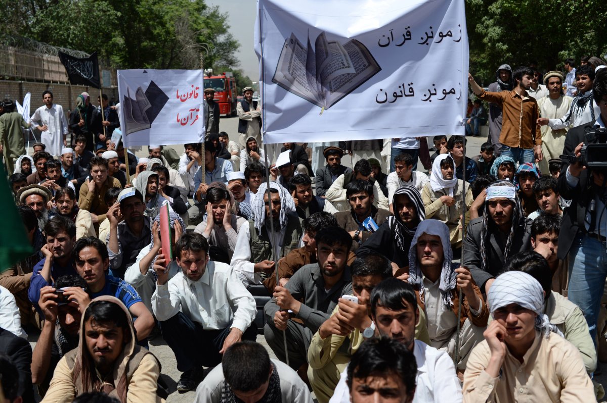 Afghan university students take part in a demonstration against the Elimination of Violence against Women law, in Kabul on May 22, 2013. (SHAH MARAI/AFP/Getty Images).