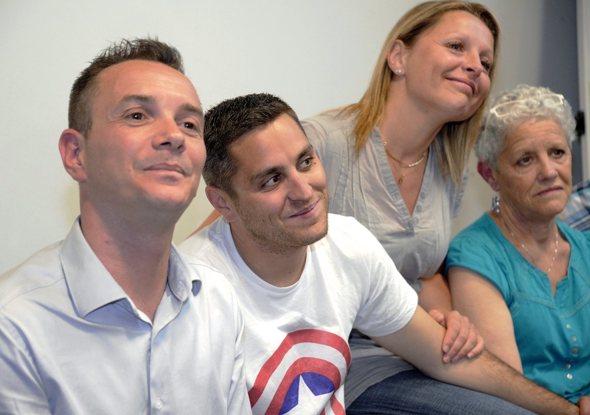 Vincent Autin (L) and his partner Bruno Boileau (2ndL), flanked by his sister (2ndR) and mother, answer journalists' questions during a press conference on May 28, 2013 in Montpellier, southern France. Montpellier mayor Helene Mandroux will celebrate on May 29, 2013 the first gay marriage in France between Autin and Boileau. 
