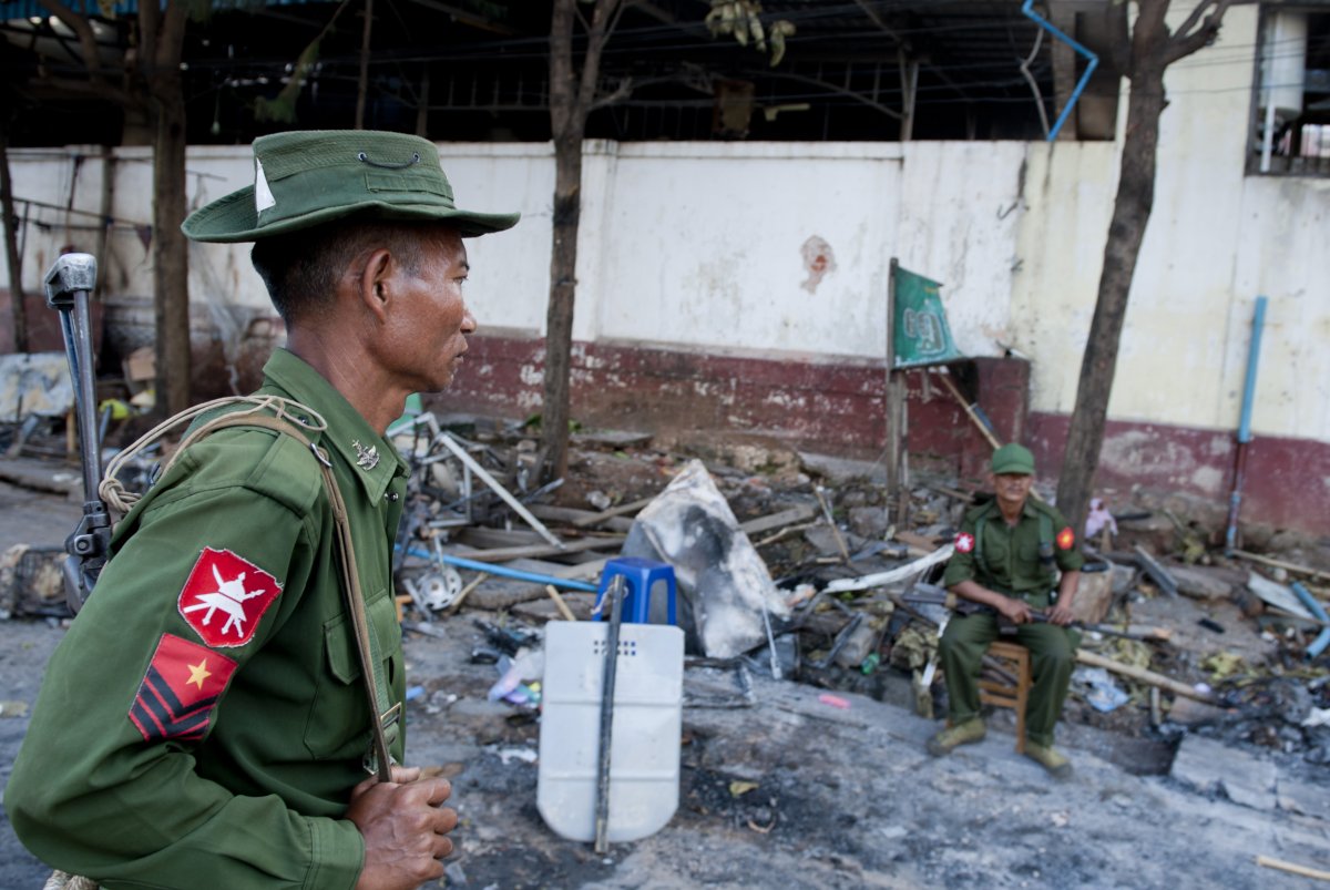 Soldiers stand guard in front of a mosque in Lashio, Shan state of Myanmar on May 29, 2013.  Myanmar's government called for calm Wednesday after mobs burned down a Muslim orphanage, a mosque and shops during a new eruption of religious violence in the east of the country. (Ye Aung Thu/AFP/Getty Images).