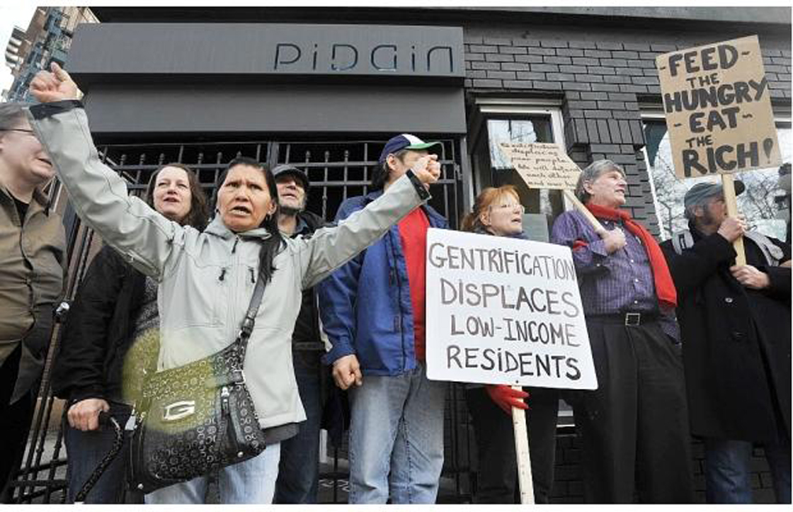 Protesters demonstrate outside Pidgin restaurant in Vancouver's downtown eastside. 