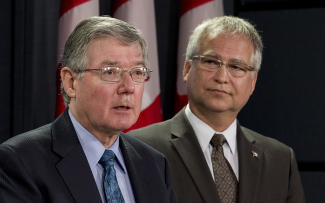 Minister of State (Science and Technology) Gary Goodyear listens to the President of the National Research Council of Canada John McDougall (left) respond to a question during a news conference Tuesday May 7, 2013 in Ottawa. 