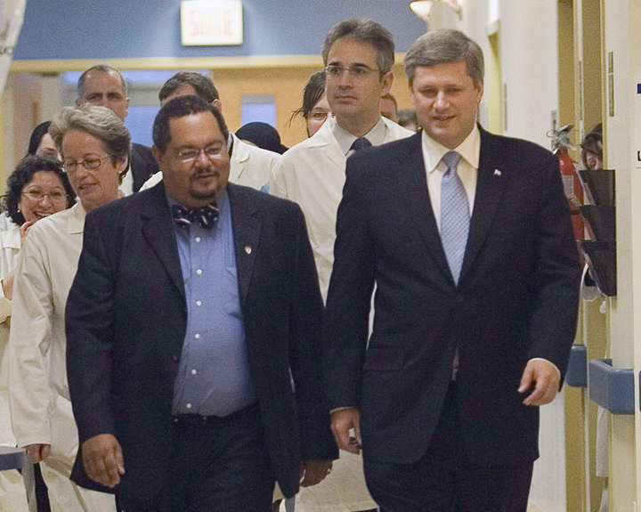 File - Arthur Porter, left, walks with Prime Minister Stephen Harper at the Montreal General hospital on Nov.24, 2006.