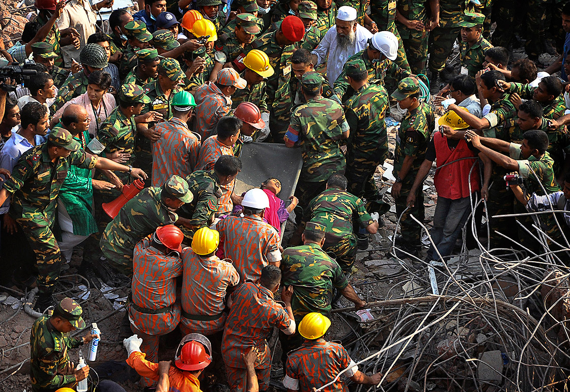 Rescuers carry a survivor pulled out from the rubble of a building that collapsed in Savar, near Dhaka, Bangladesh, Friday, May 10, 2013. 