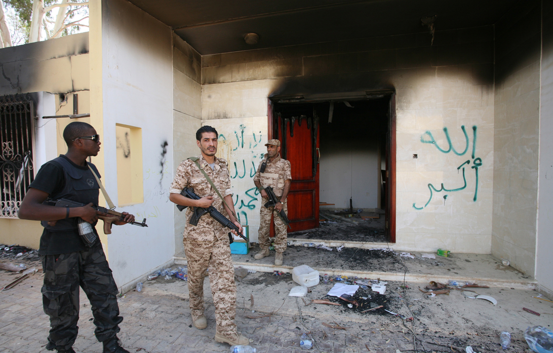 FILE - In this Sept. 14, 2012 file photo, Libyan military guards check one of the U.S. Consulate's burnt out buildings in Benghazi, Libya.