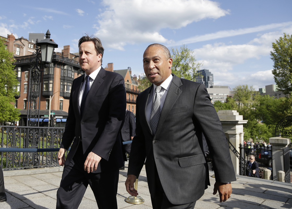 British Prime Minister David Cameron, left, walks with Massachusetts Gov. Deval Patrick into the Massachusetts Statehouse in Boston, Monday, May 13, 2013. Cameron met with Patrick to offer his condolences and discuss lessons that can be learned from the Boston Marathon attacks. 