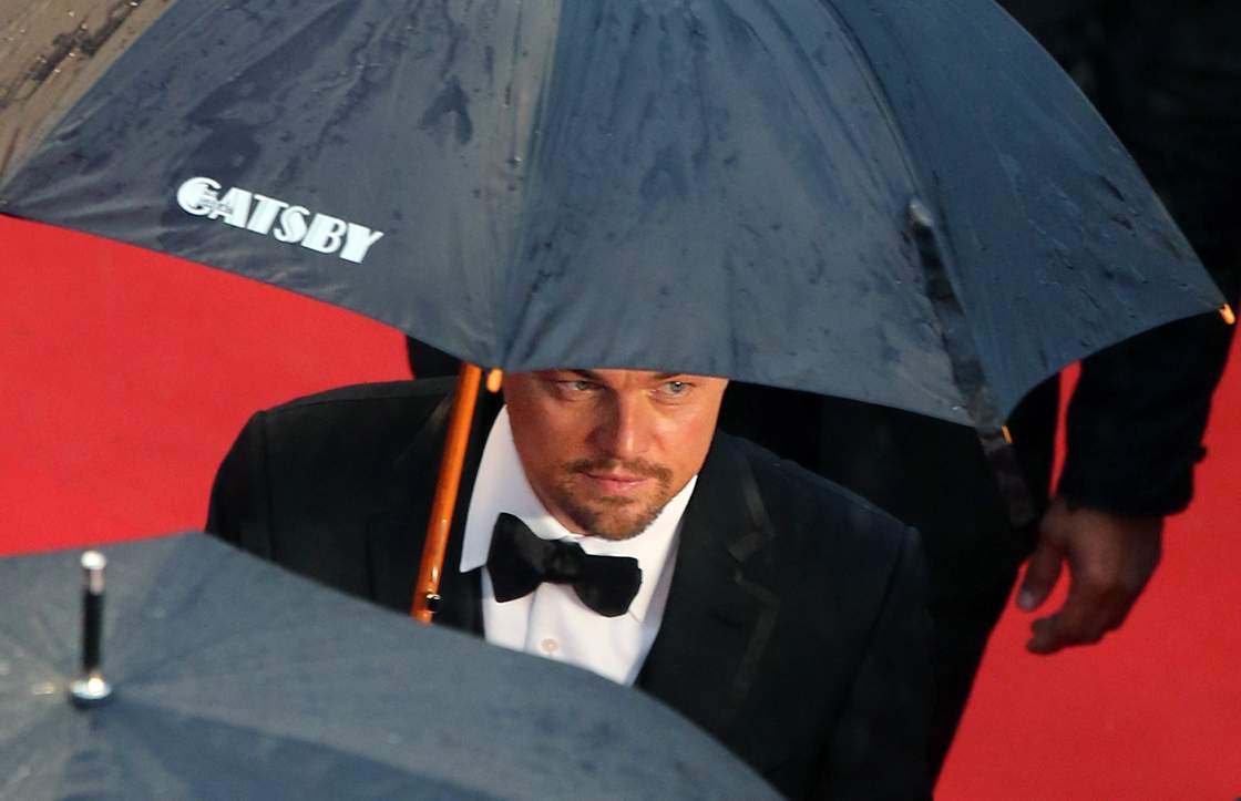 Leonardo DiCaprio takes shelter on the Cannes red carpet.