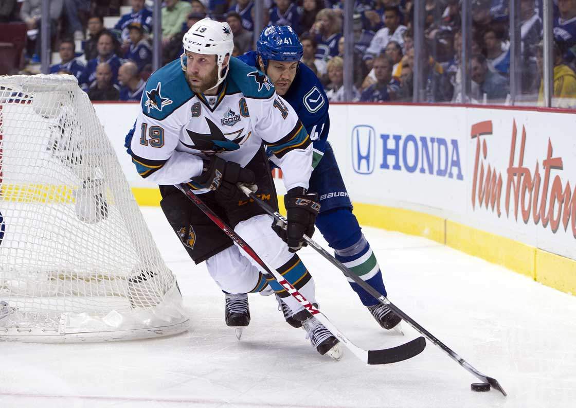 Andrew Alberts of the Vancouver Canucks tries to check Joe Thornton of the San Jose Sharks off the puck during the third period in Game One of the Western Conference Quarterfinals of the 2013 NHL Stanley Cup Playoffs, May 01, 2013 at Rogers Arena in Vancouver.  