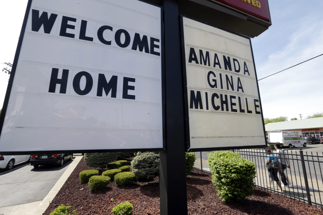 FILE - In this Thursday, May 9, 2013 file photo, a "Welcome Home" sign is posted at a restaurant near a crime scene where three women were held captive for a decade in Cleveland. 