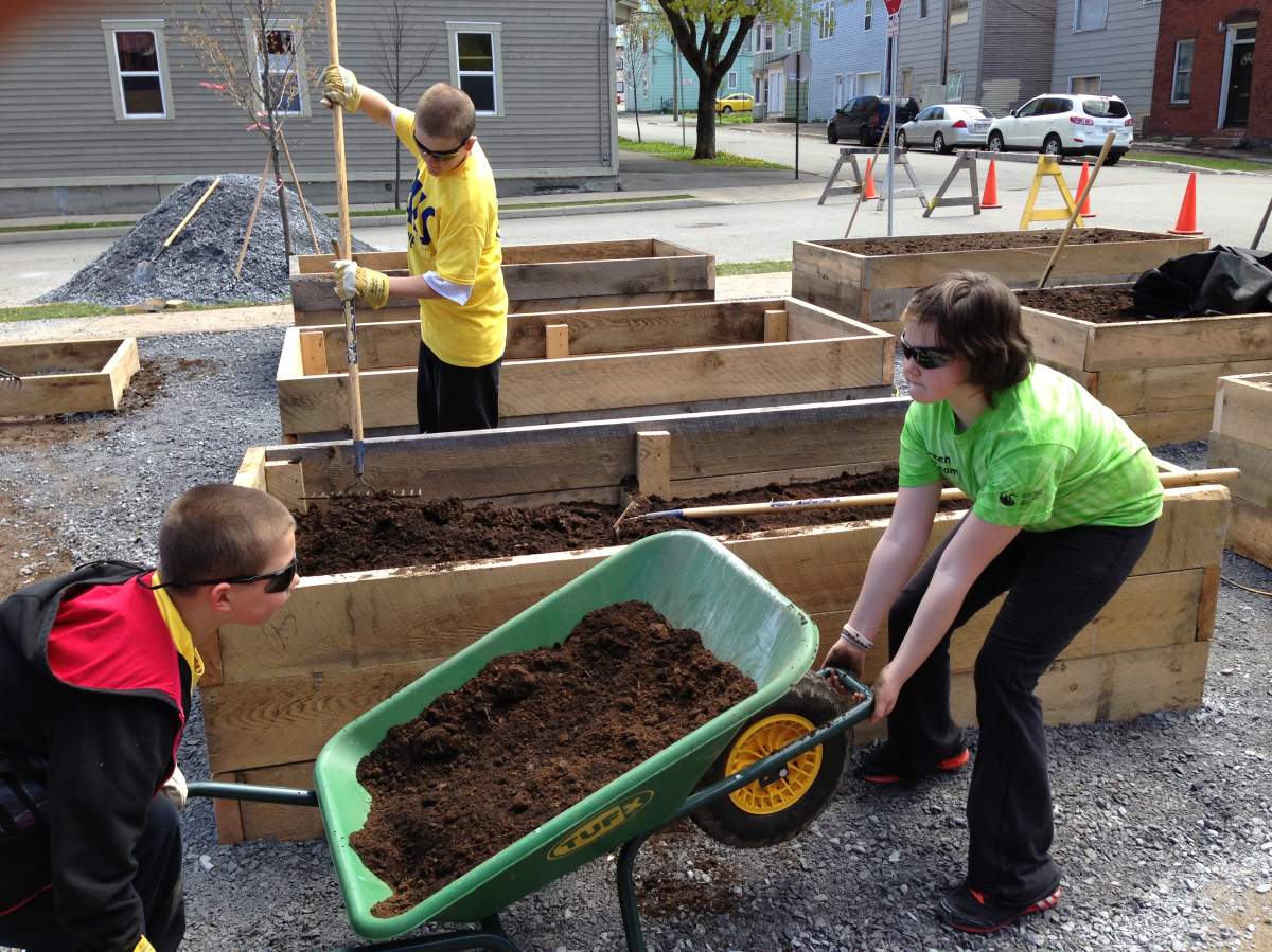 Lorne Middle School students working the dirt for a new garden.
