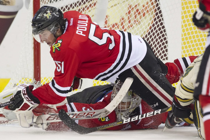 Portland Winterhawks defenceman Derrick Pouliot dives over goaltender Mac Carruth to block a shot from the London Knights during the third period of Memorial Cup semifinal action in Saskatoon, Sask. on Friday, May 24, 2013. The Winterhawks defeat the Knights 2-1.