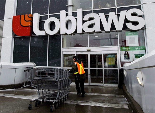 A Loblaws employee brings in shopping carts in Toronto on Wednesday, Feb. 18, 2009.