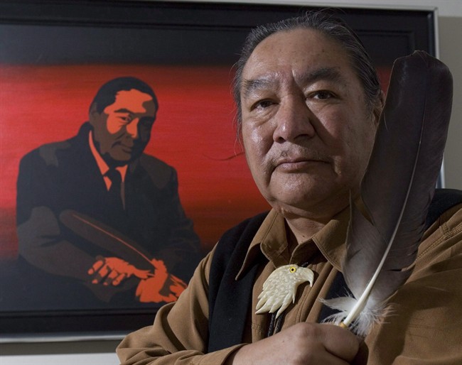 Former politician and honourary Cree Chief Elijah Harper holds up one of two eagle feathers he held during the Meech Lake proceedings, in Ottawa Tuesday, May 20, 2008. 