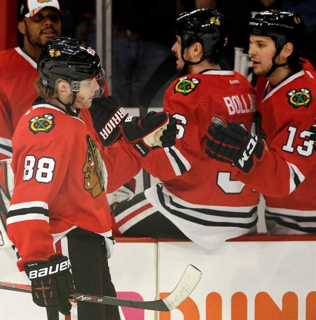 Chicago Blackhawks' Patrick Kane (88) celebrates with teammates after scoring a goal against the Detroit Red Wings during the first period of Game 2 of an NHL hockey Stanley Cup playoffs Western Conference semifinals Saturday, May 18, 2013, in Chicago. 