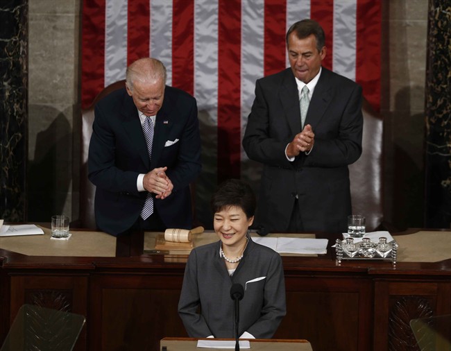 South Korea's President Park Geun-hye finishes her address to a joint session of Congress on Capitol Hill in Washington, Wednesday, May 8, 2013. At rear are Vice President Joe Biden, left, and House Speaker John Boehner of Ohio. (AP Photo/Charles Dharapak).