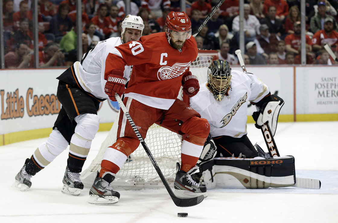 Detroit Red Wings center Henrik Zetterberg (40) protects the puck from Anaheim Ducks center Ryan Getzlaf (15) as goalie Jonas Hiller (1), of Switzerland, looks on in the second period in Game 6 of a first-round NHL hockey Stanley Cup playoff series in Detroit, Friday, May 10, 2013.