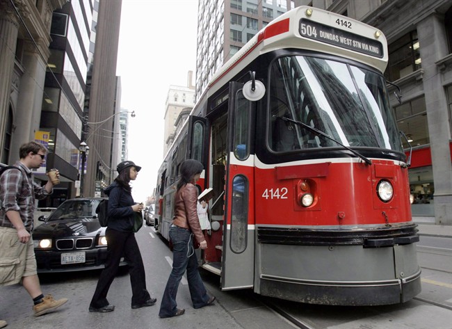 A TTC streetcar takes on passengers in a file photo. The number of rides taken by children has increased dramatically since free fares were introduced.