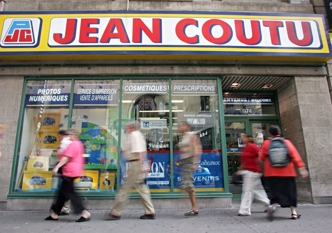 Pedestrians walk past a Jean Coutu pharmacy in Montreal.