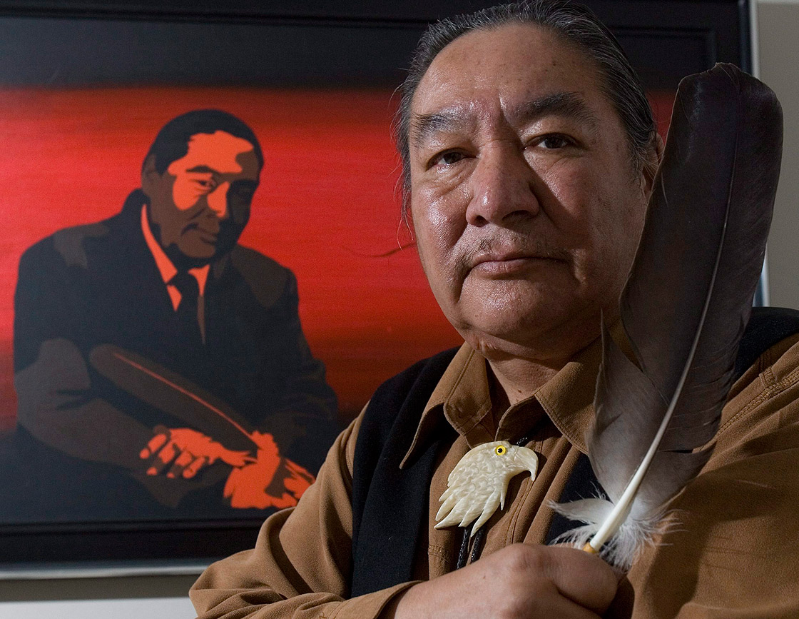 In this file photo, former politician and honourary Cree Chief Elijah Harper holds up one of two eagle feathers he held during the Meech Lake proceedings, in Ottawa Tuesday, May 20, 2008.