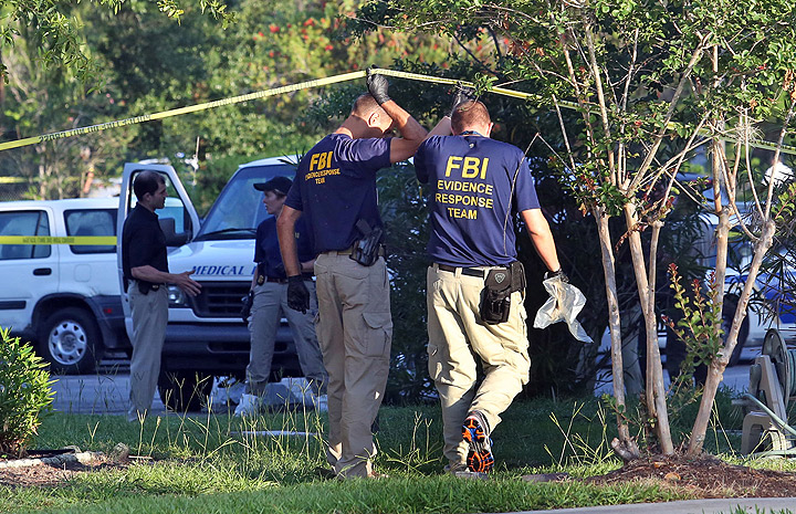 The medical examiner arrives as FBI evidence response team gather in front of an apartment Wednesday, May 22, 2013 in Orlando, Florida, after an FBI agent shot and killed a man who was questioned in connection with the Boston Marathon bombings.