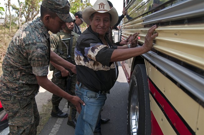 A man is checked for weapons by soldiers at a checkpoint in Mataquescuintla, Guatemala, Thursday, May 2, 2013. Guatemala's government declared a state of emergency and banned public gatherings Thursday in four townships east of the capital including Mataquescuintla, following several days of violent clashes between police and anti-mining protesters. The government sent in 500 police officers and 2,000 soldiers, some in armored personnel vehicles. It said protesters were armed with guns and explosives. Clashes have involved police, mine security guards and local protesters. (AP Photo/Luis Soto).