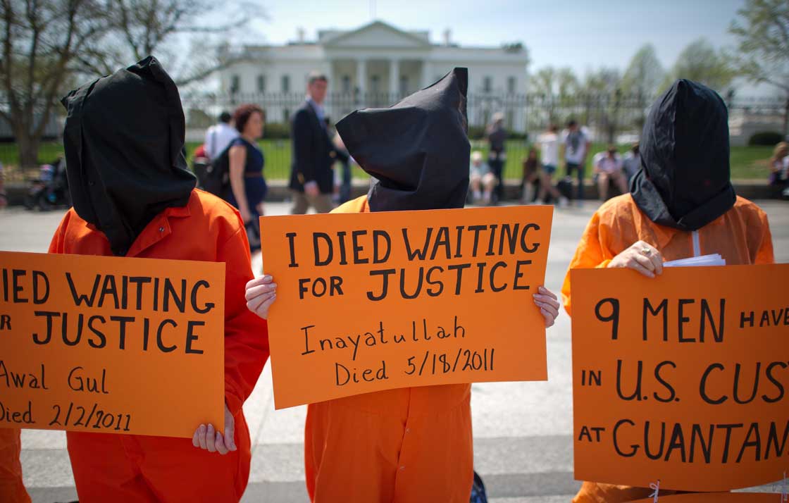 Black hooded human rights activists hold banners demanding the closing of Guantanamo Bay during a protest outside the White House. The House has voted in favour of keeping open the U.S. detention centre. 