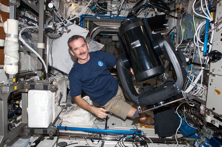 Hadfield gets ready to set up  the SERVIR Environmental Research and Visualization System (ISERV), a Celestron telescope that will serve as an environmental monitoring system, helping developing nations during natural disasters.