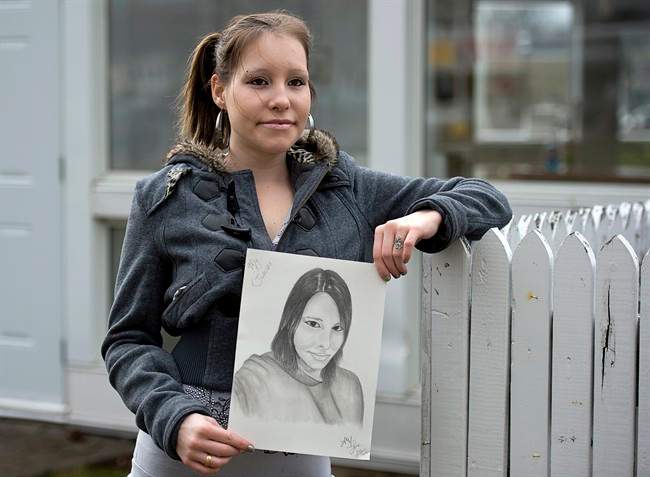 Julie Young holds a portrait drawn by her boyfriend Steve Mehlenbacher in Truro, N.S. on Friday, April 19, 2013. Young has established a relationship with the federal prisoner was is serving time for bank robbery in British Columbia. She met Mehlenbbacher on a dating/frienship website that connects prisoners with people on the outside.