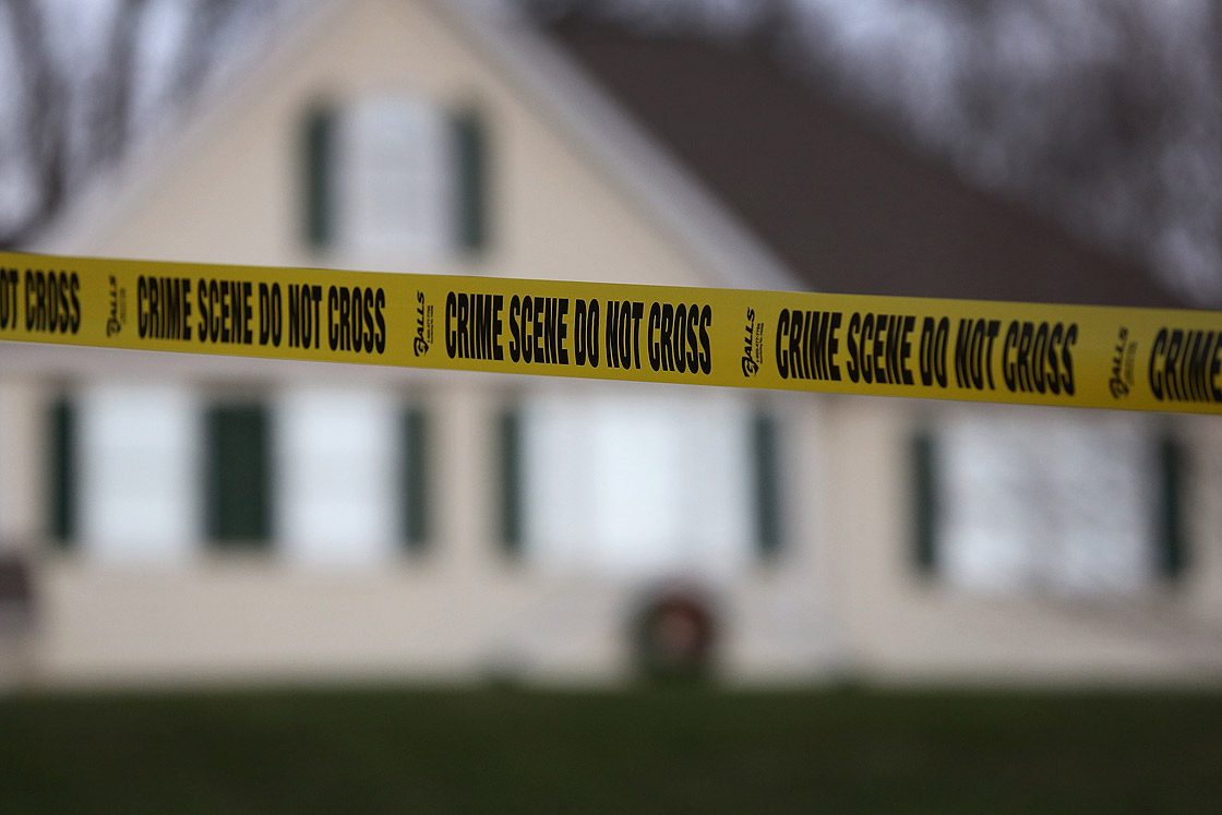 Police tape stretches across the front yard of the Lanza residence on December 19, 2012 in Newtown, Connecticut.
