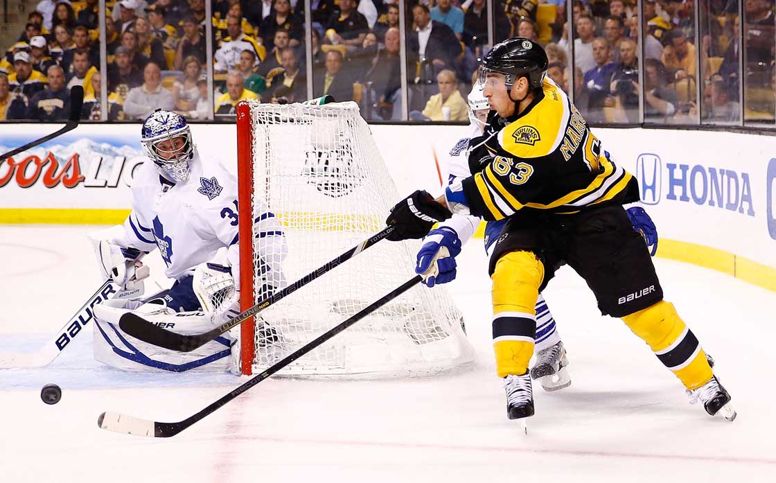 Brad Marchand of the Boston Bruins makes a pass in front of the net past James Reimer of the Toronto Maple Leafs in Game 1 of the Eastern Conference Quarterfinals during the 2013 NHL Stanley Cup Playoffs on May 1, 2013 at TD Garden in Boston. 