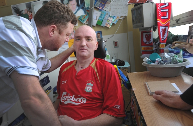 Friend Charlie Cooper, left, talks with Chris (Bunce) Thomas at Lions Gate Hospital in North Vancouver Tuesday.


