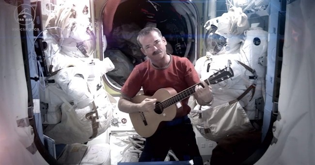 This image provided by NASA shows astronaut Chris Hadfield recording the first music video from space Sunday May 12, 2013. The song was his cover version of David Bowie's Space Oddity.