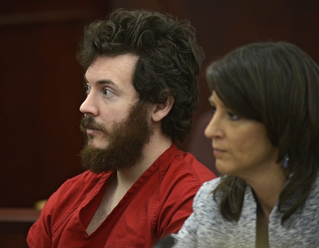 FILE - In this March 12, 2013 file photo, James Holmes, left, and defense attorney Tamara Brady appear in district court in Centennial, Colo. for his arraignment. Lawyers for Holmes, the man accused of killing 12 people and injuring 70 in a Colorado movie theater, said Tuesday May 7, 2013 he wants to change his plea to not guilty by reason of insanity.