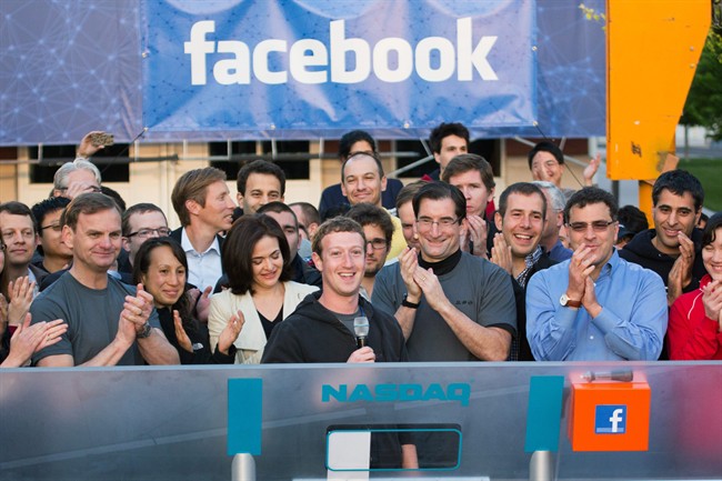 Facebook founder, Chairman and CEO Mark Zuckerberg, center, rings the opening bell of the Nasdaq stock market, from Facebook headquarters in Menlo Park, Calif. 