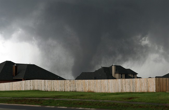 A tornado moves past homes in Moore, Okla. on Monday, May 20, 2013. Moore has been struck by two serious tornadoes over the past 15 years.