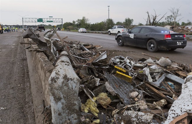 Debris lays on the northbound lanes of I-35 just south of SW 4th street in Moore, Okla. after a tornado moves through the area on Monday, May 20, 2013. 